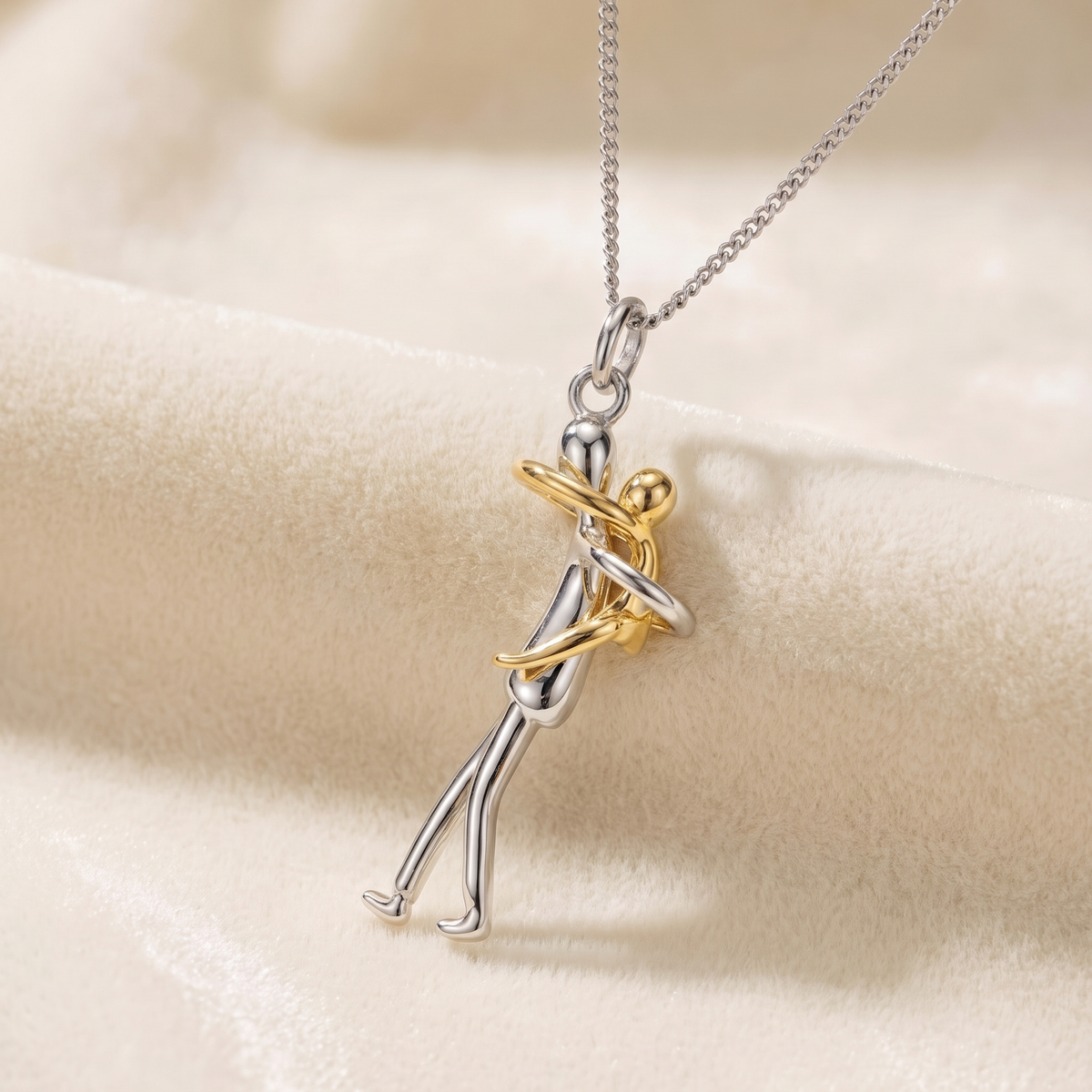 Eternal Love pendant of two embracing figures, silver and gold